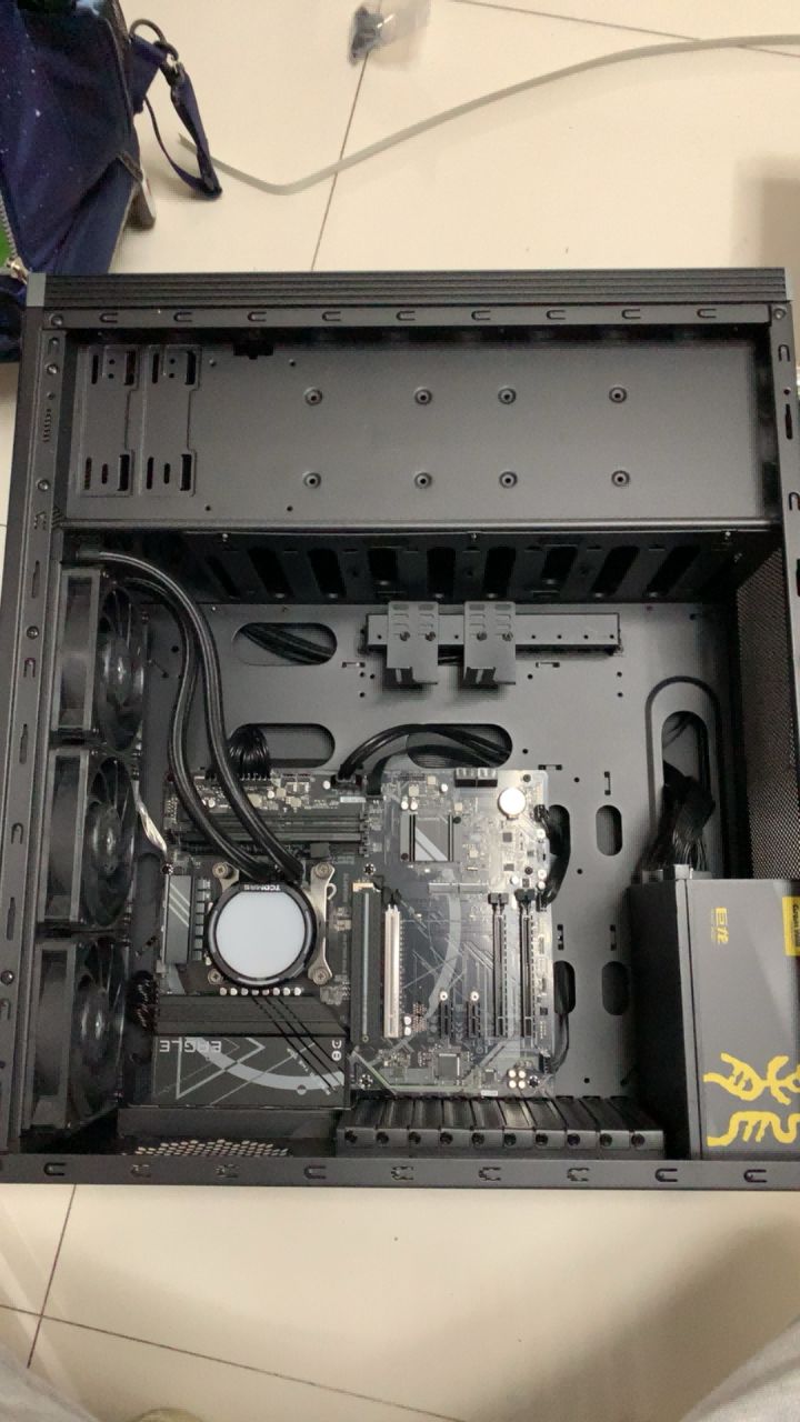 Open computer case with motherboard, liquid cooling, and power supply