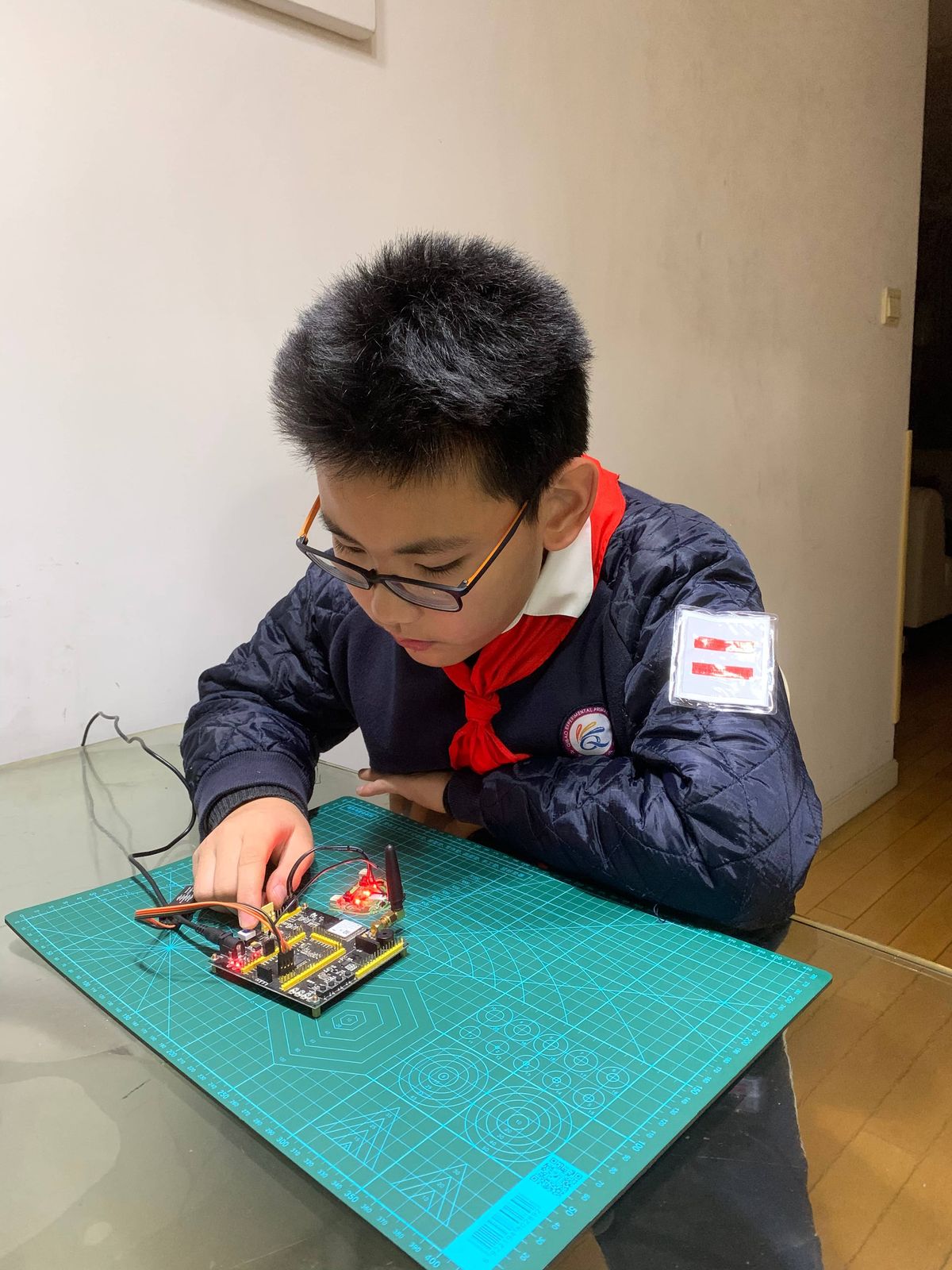 Tianqiqi as a middle school student wiring a circuit board