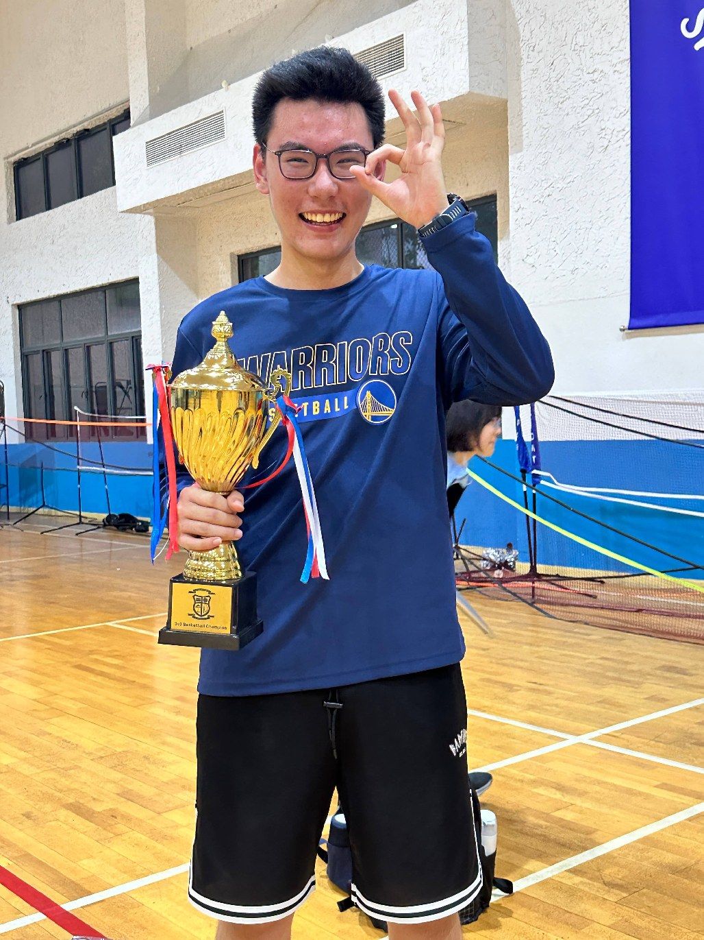 Tianqiqi holding the school 3-on-3 championship trophy